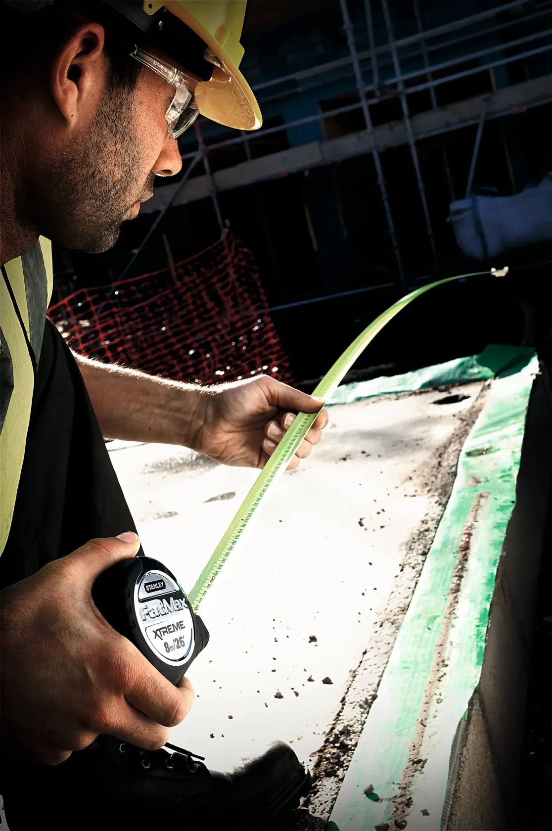 Photo of STANLEY 0-33-887 tape measure used by worker on construction site.