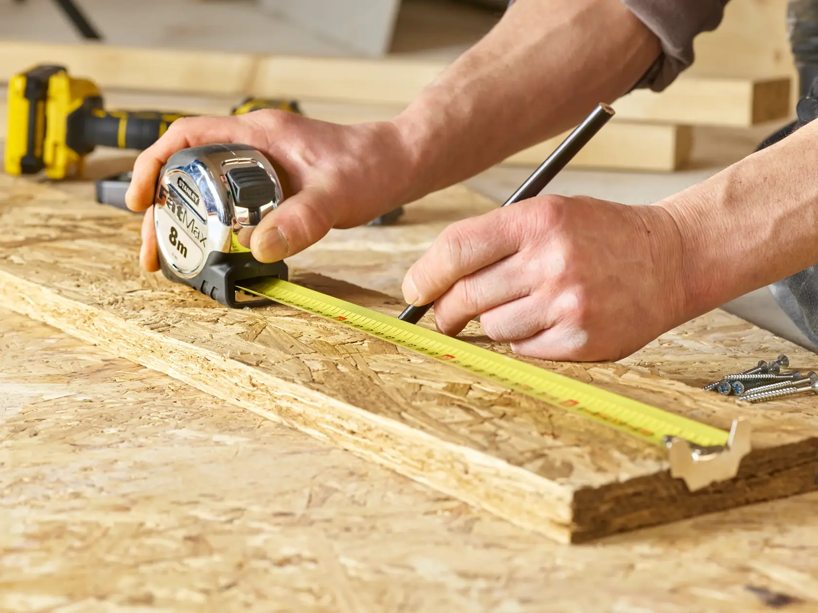 Stanley 0-33-892 tape measure for woodworking, shown measuring on plywood surface.