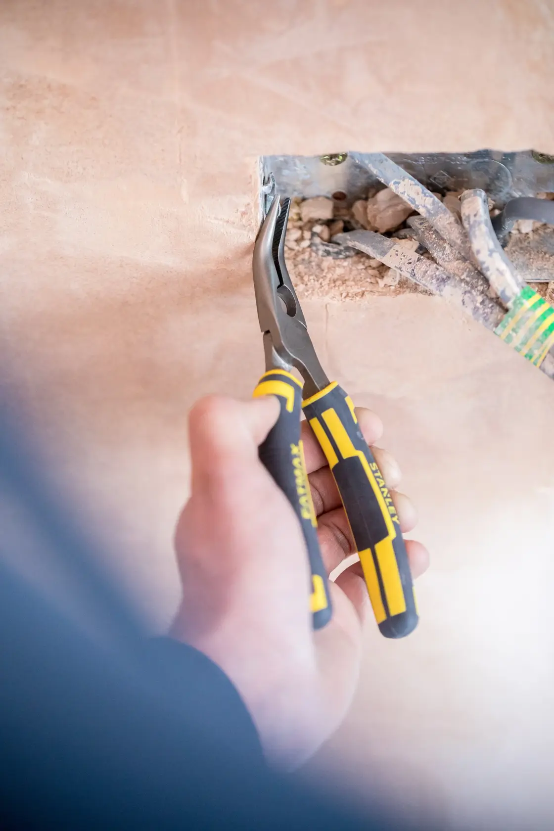 STANLEY 0-89-871 long nose pliers with yellow and black handles used for electrical wiring.