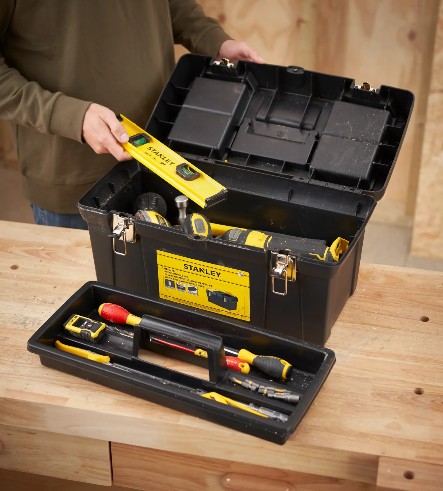 STANLEY 1-92-066 toolbox in photography, open showing assorted hand tools on a wooden workbench.
