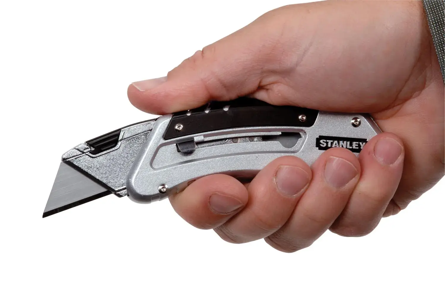 STANLEY 9-10-810 utility knife, silver with black accents, held in a right hand, side view.