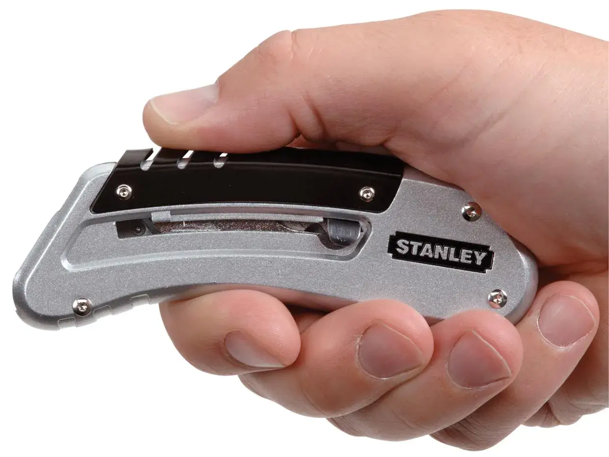 Photo of STANLEY 9-10-810 folding utility knife held in hand, silver and black color.