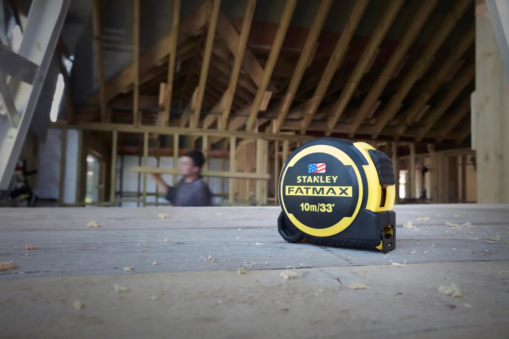 STANLEY FMHT0-36336 FATMAX 10m/33ft tape measure on construction site wooden floor.