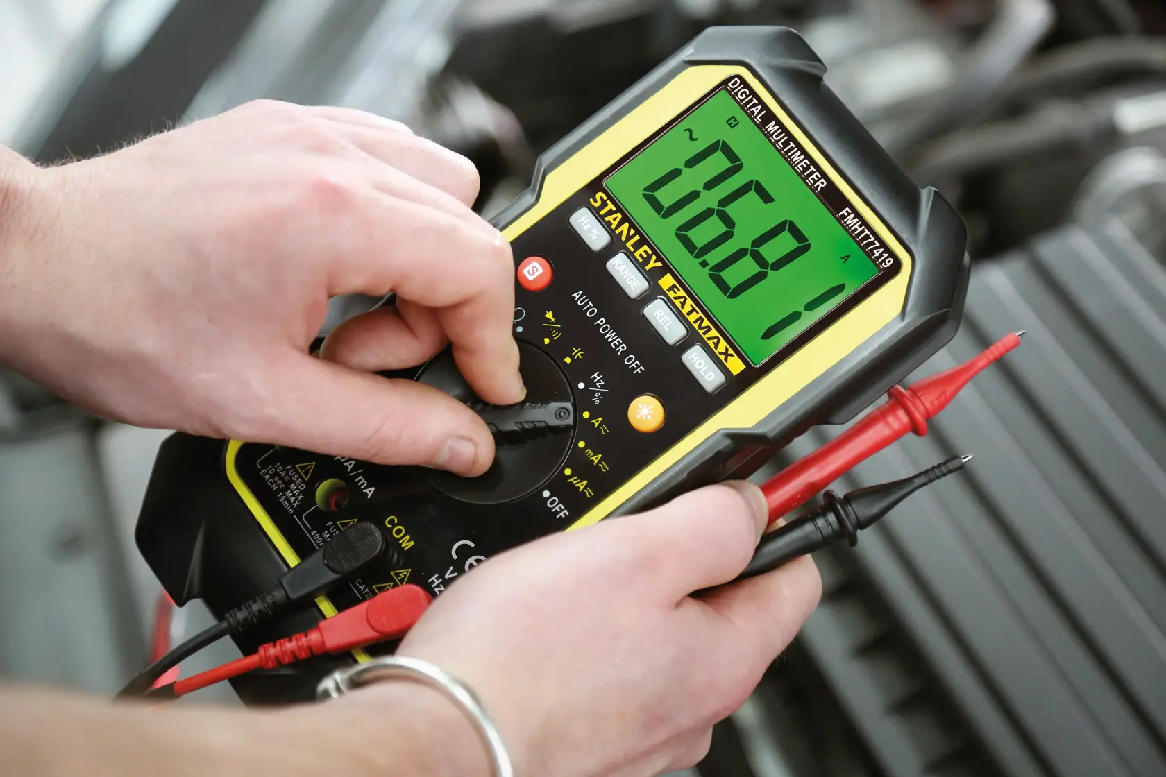 STANLEY FMHT0-77419 digital multimeter with large display in use, photographed close-up.