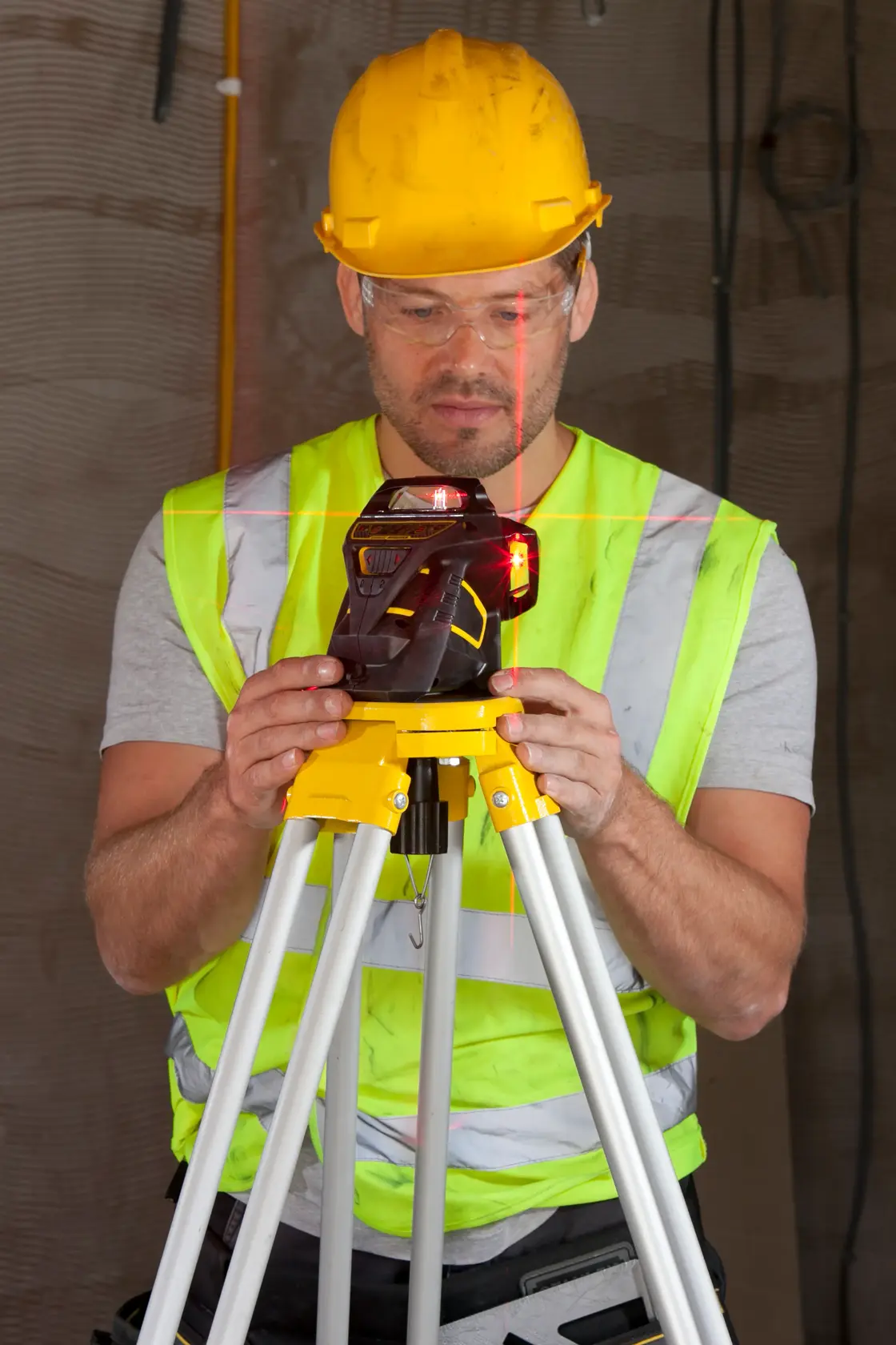 STANLEY FMHT1-77357 laser level on tripod, front angle, used on construction site.
