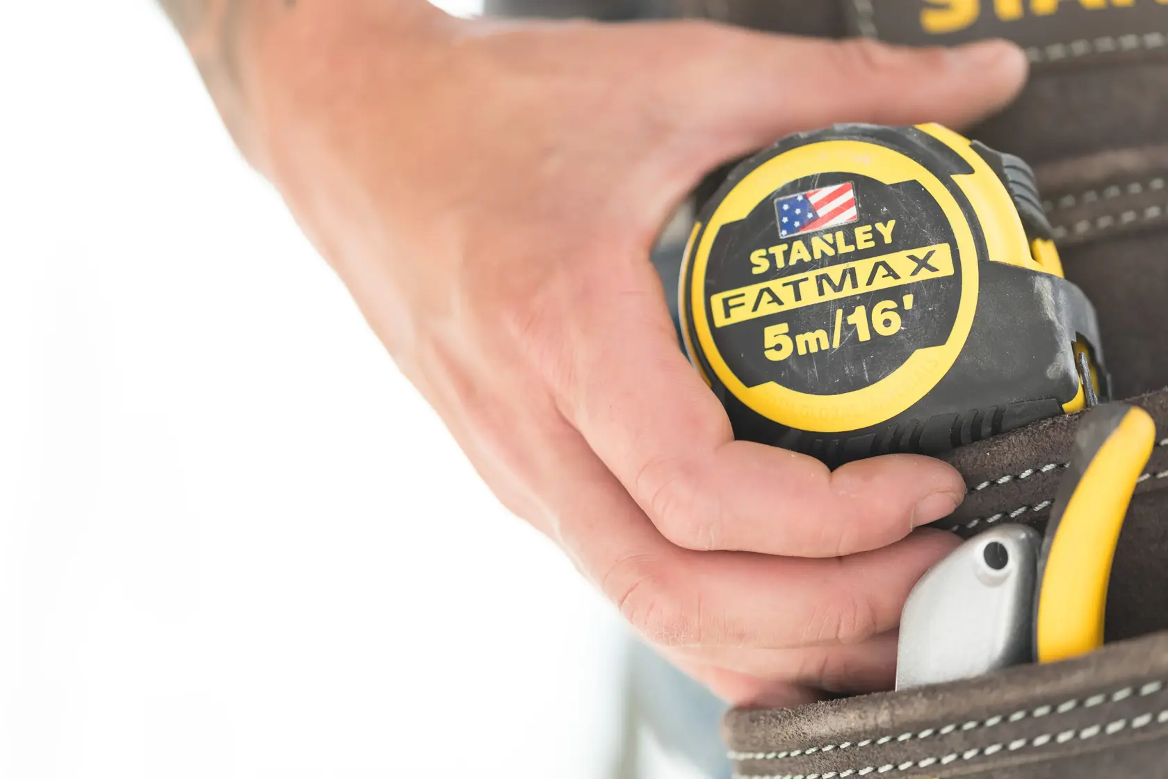 Photo of STANLEY FMHT36317-0 FATMAX 5m/16' tape measure held in a tool belt pouch.