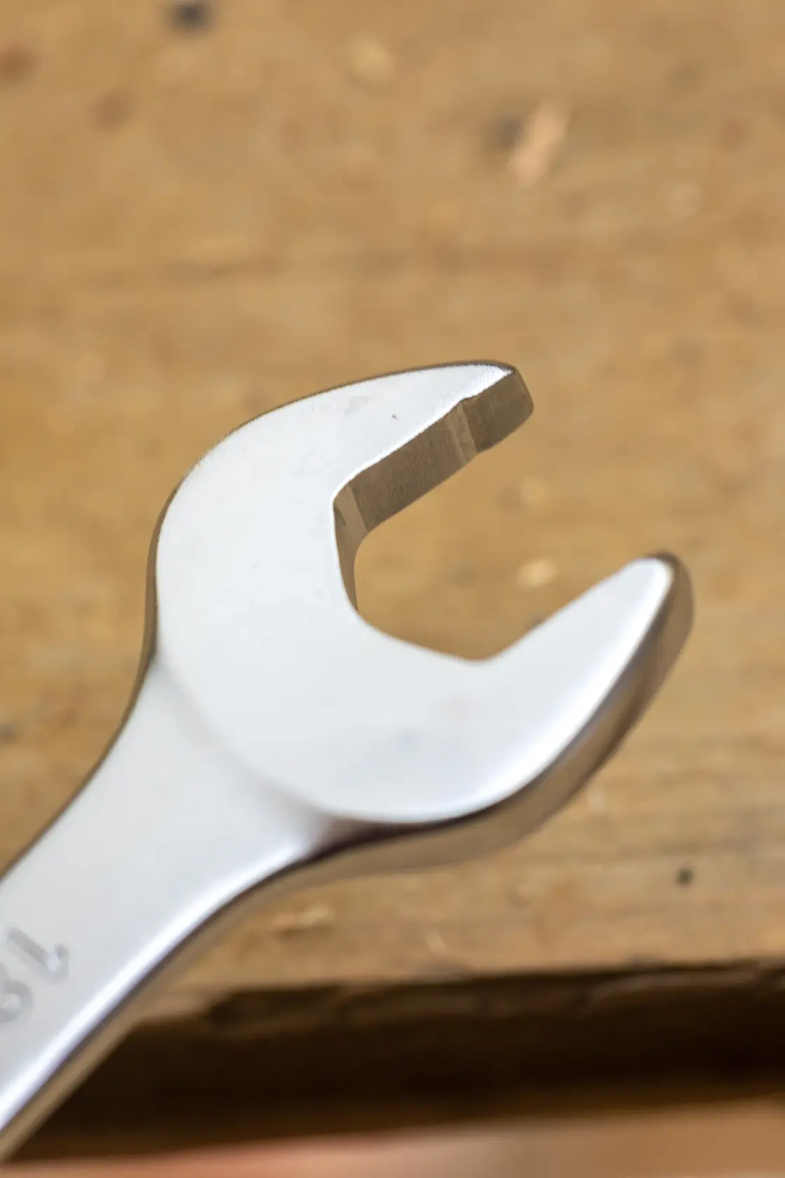 STANLEY FMMT13037-0 open-end wrench, silver finish, close-up angled view, tool on wooden surface.