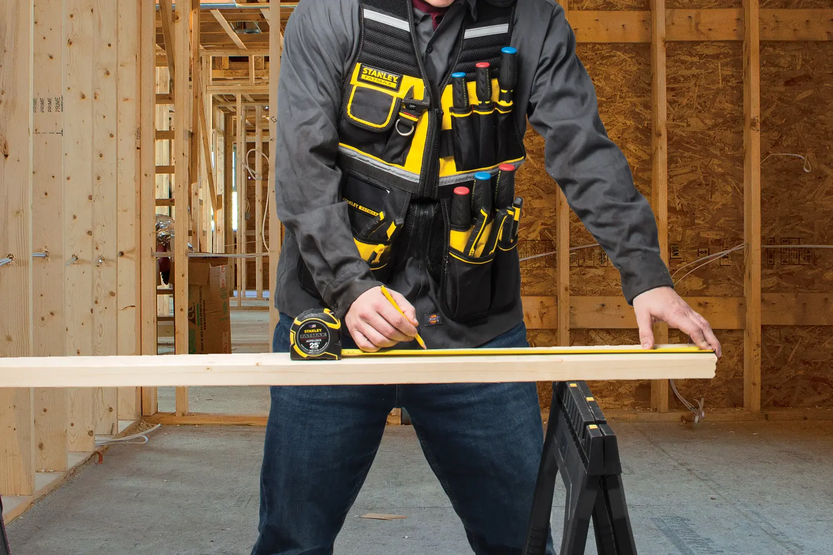 STANLEY FMST1-71181 tool vest with pockets, worn by person in construction setting.