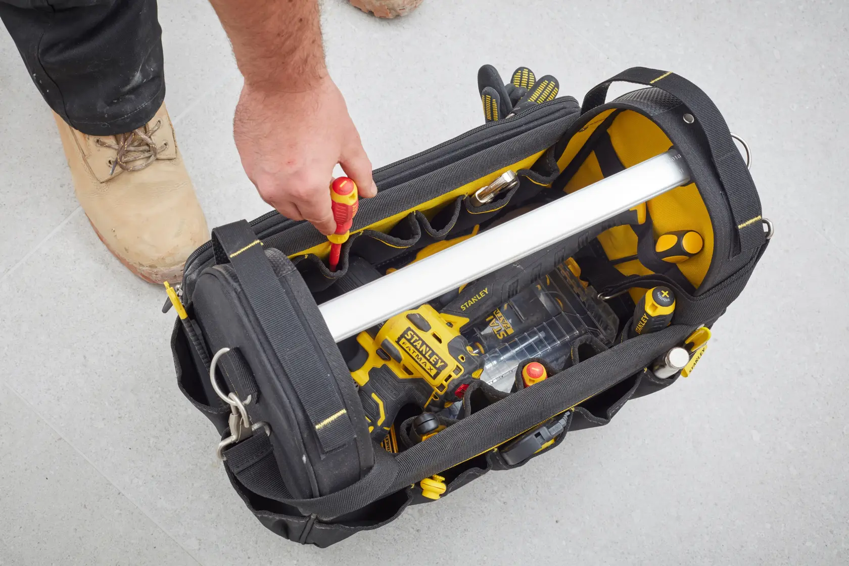 STANLEY FMST83296-1 tool bag top view showing organized tools and yellow accents in use.