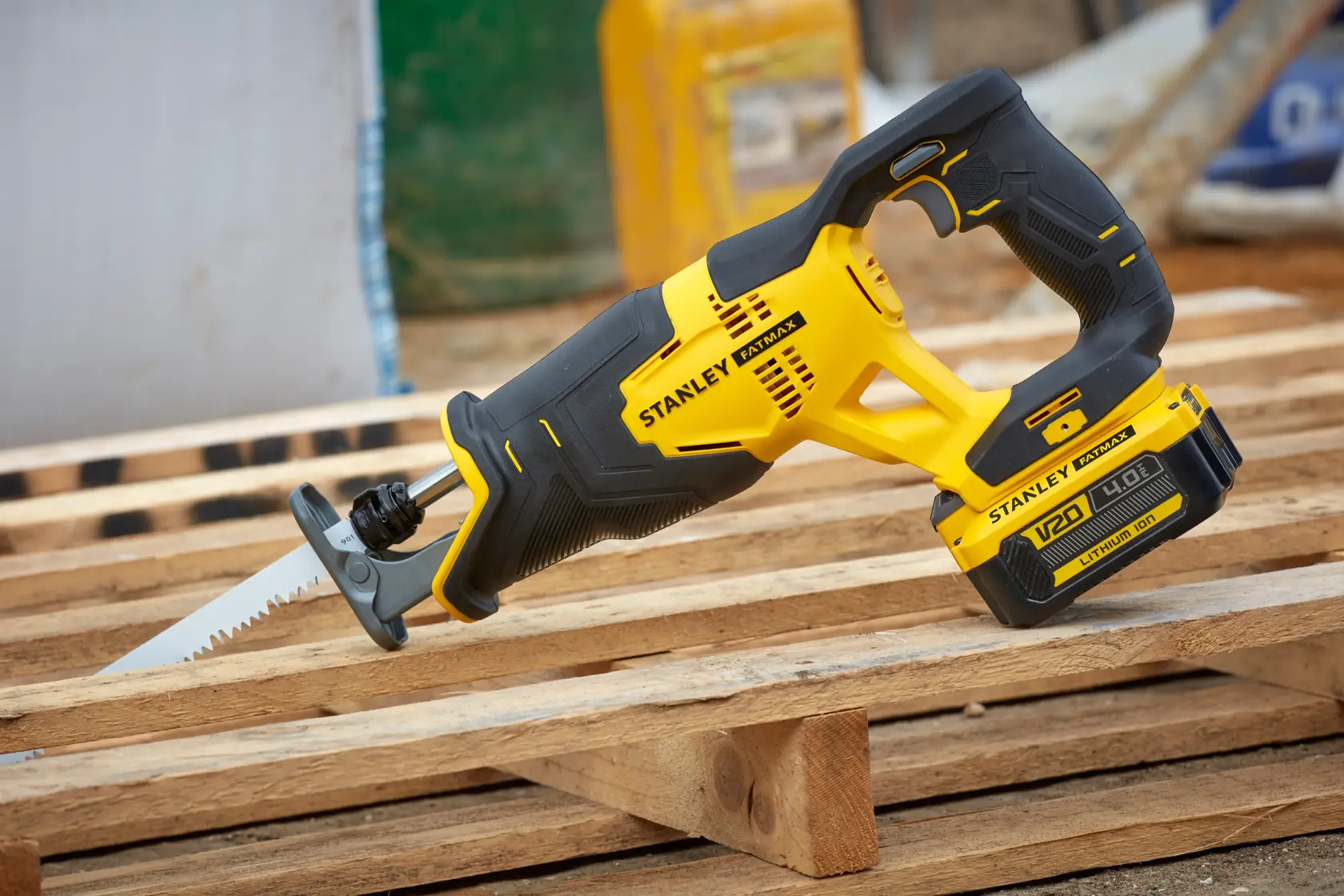 STANLEY SFMCS300M1K cordless reciprocating saw with yellow and black body on wooden pallet.