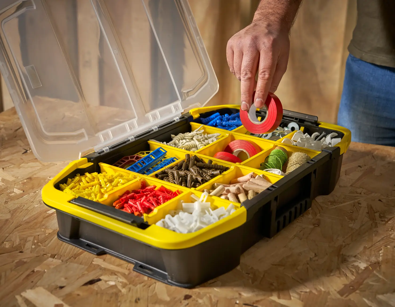 STANLEY STST1-71983 organizer box with yellow compartments filled with assorted hardware, angled view.