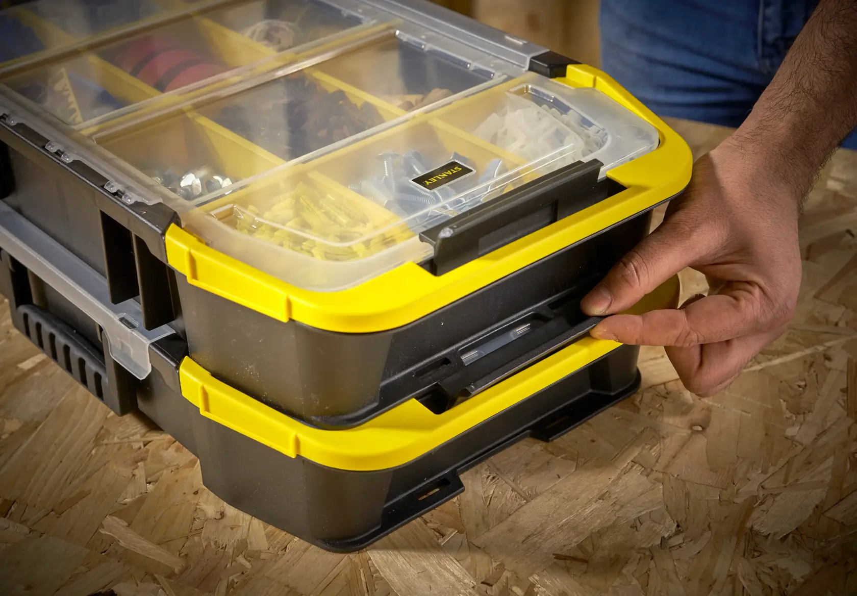 STANLEY STST1-71983 organizer box with yellow trim, transparent lid, shown in use on a wooden surface.