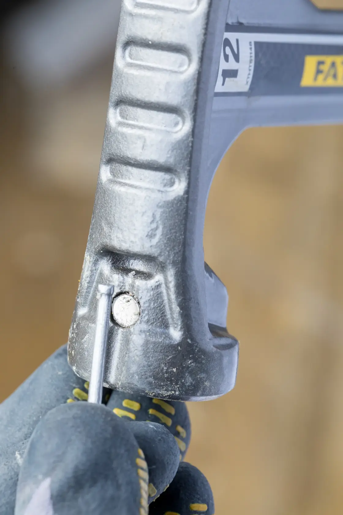 STANLEY XTHT1-51148 hand saw close-up showing adjustment mechanism, worker with gloves adjusting blade.